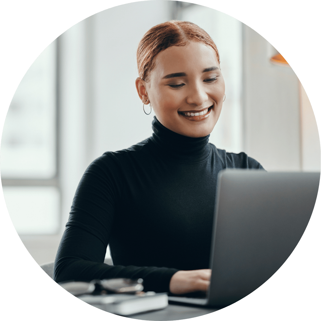 A woman looking at a laptop