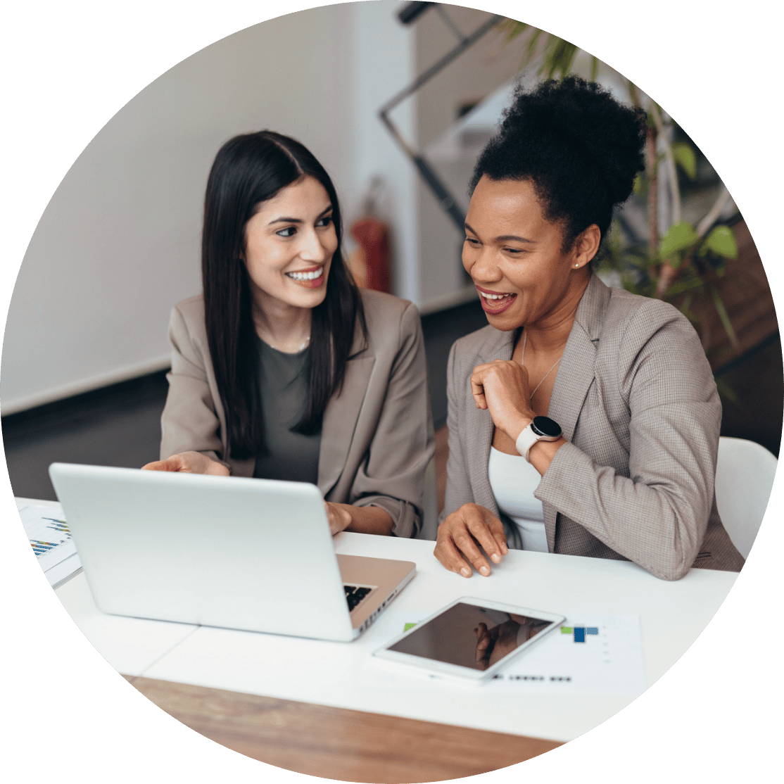 Two women looking at a laptop