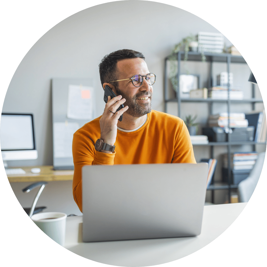 A man making a phone call at his desk
