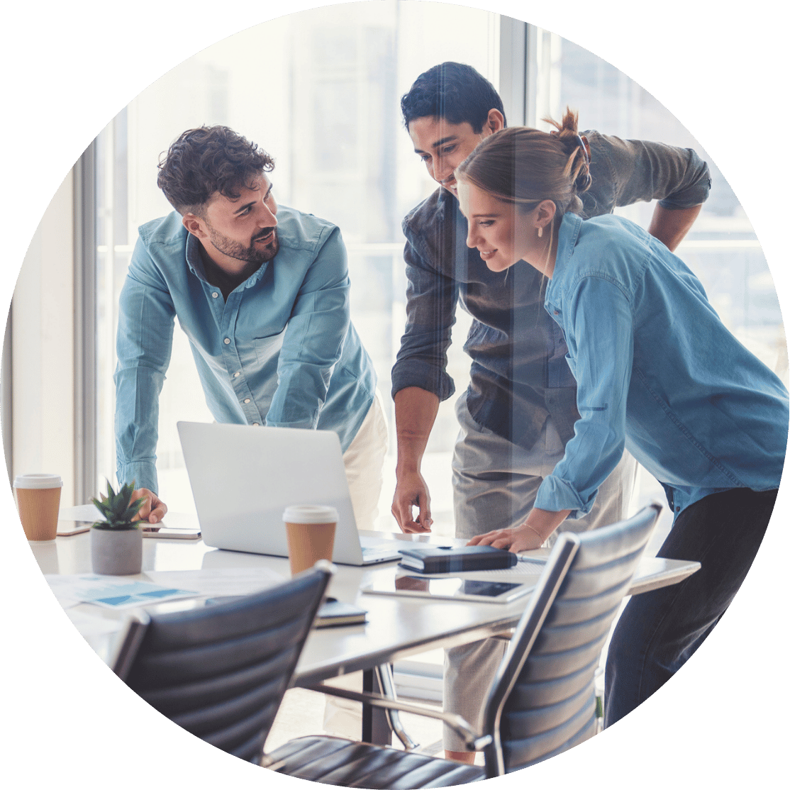 Three coworkers discussing around a laptop