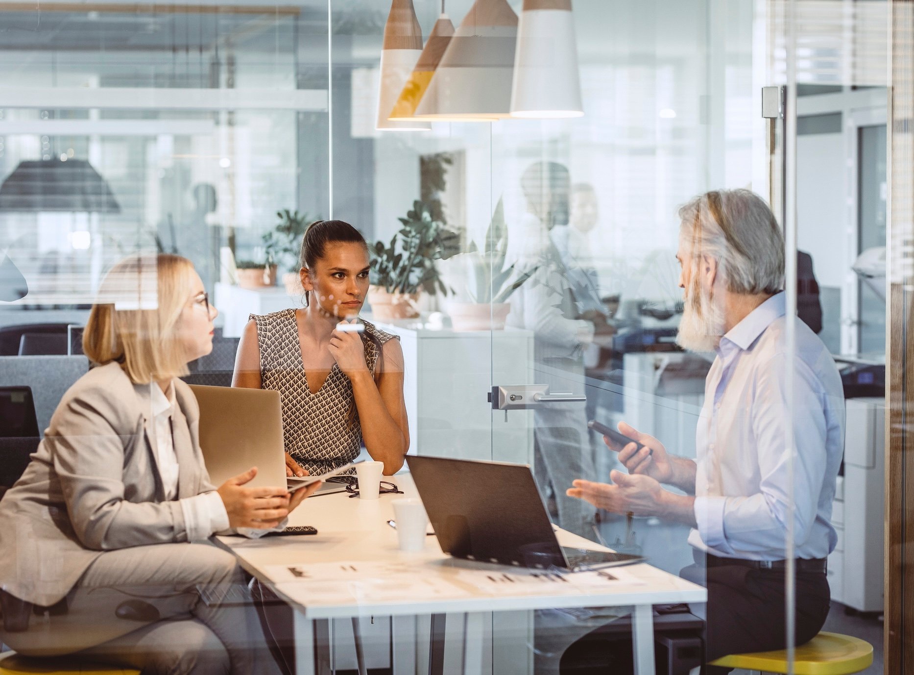 Three coworkers meeting in an office