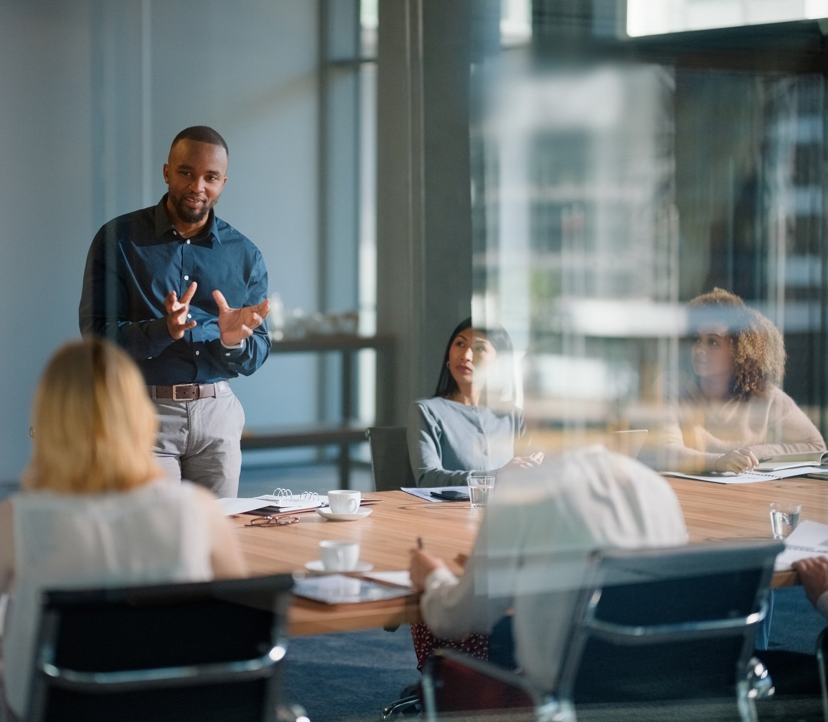 A man speaking to a group in an office