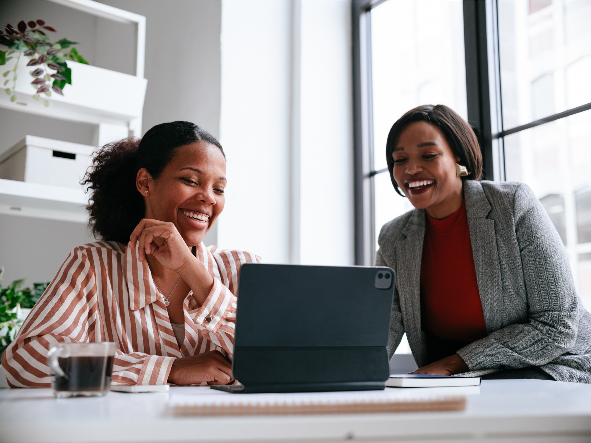 Two professionals reviewing a tablet