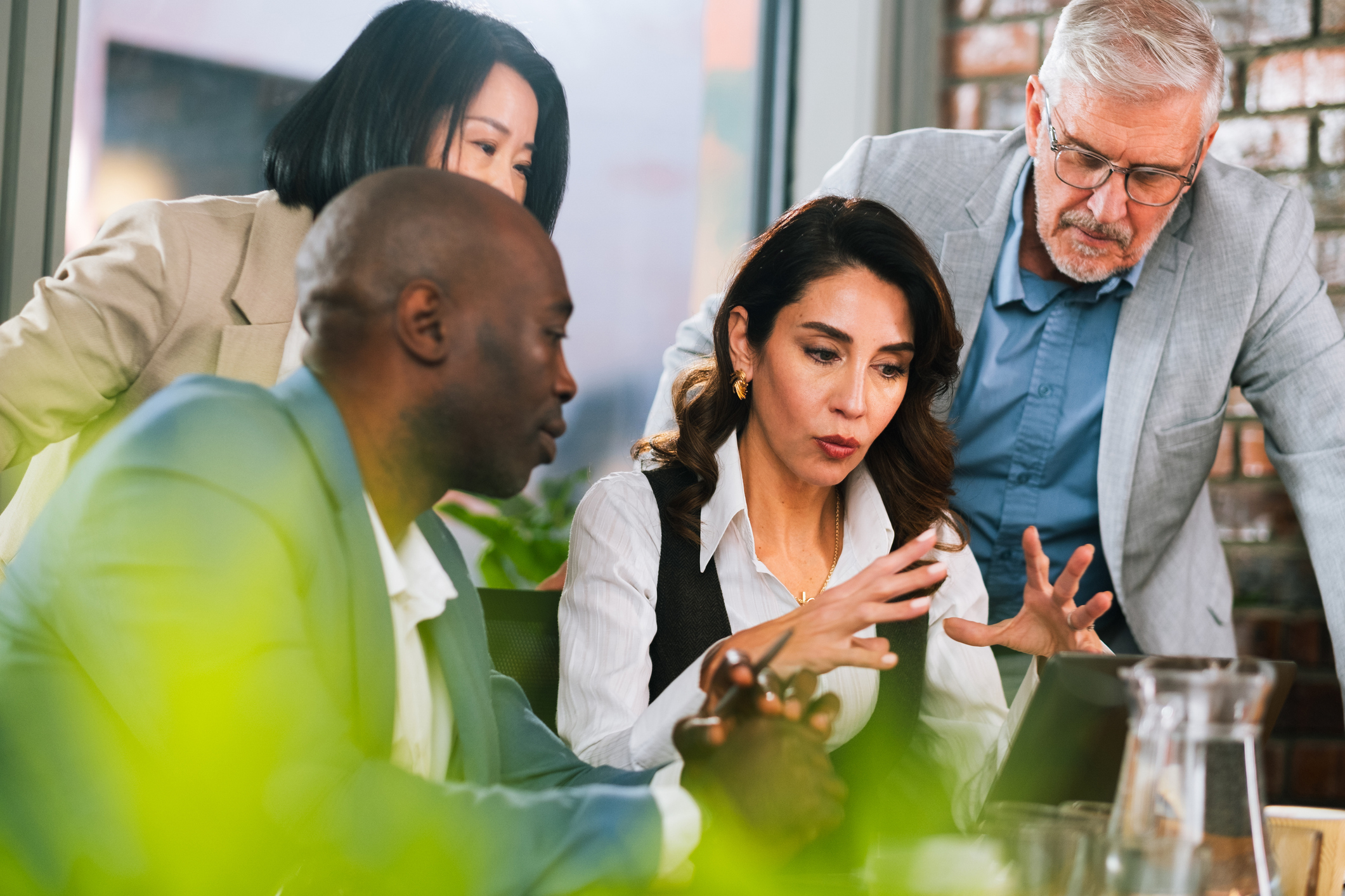 Four coworkers gathered around a phone