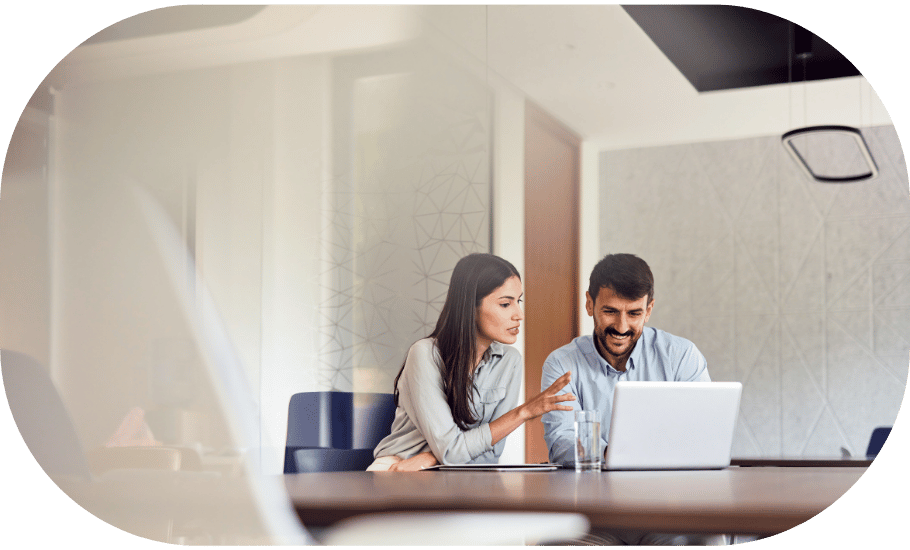 Two coworkers around a laptop