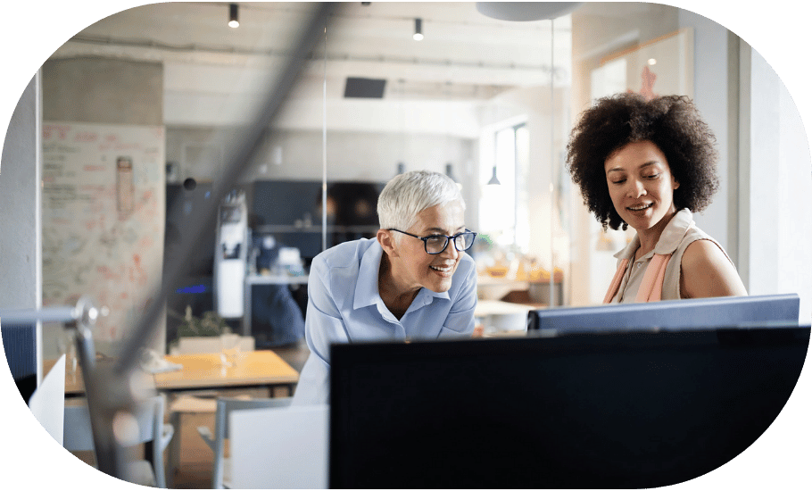 Two coworkers around a desktop