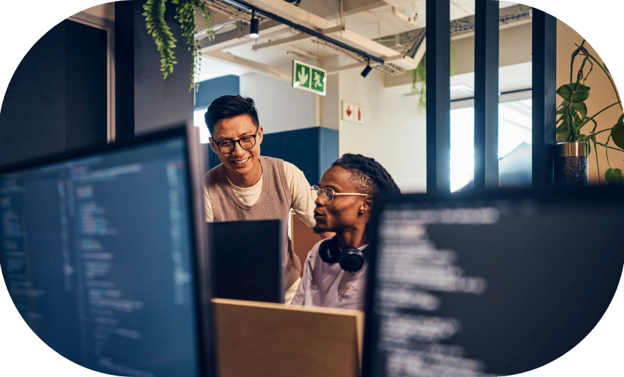 Two coworkers around a computer