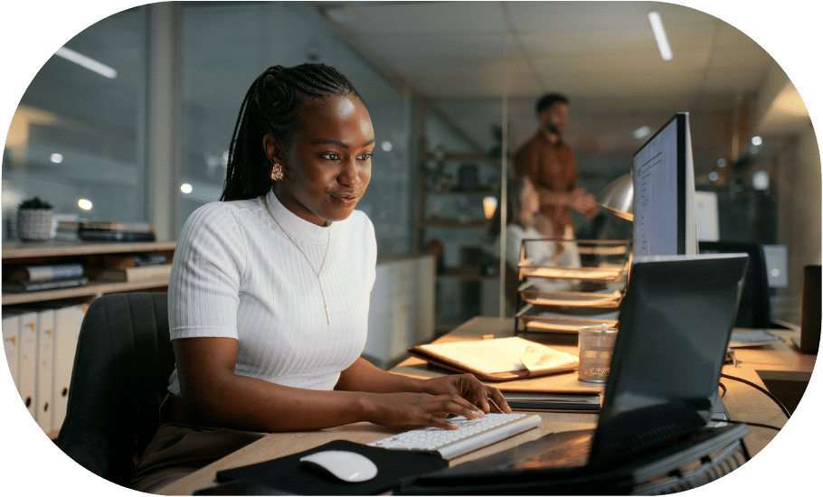 A woman typing at her desk