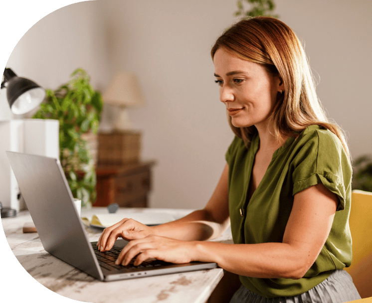 A woman typing on her laptop