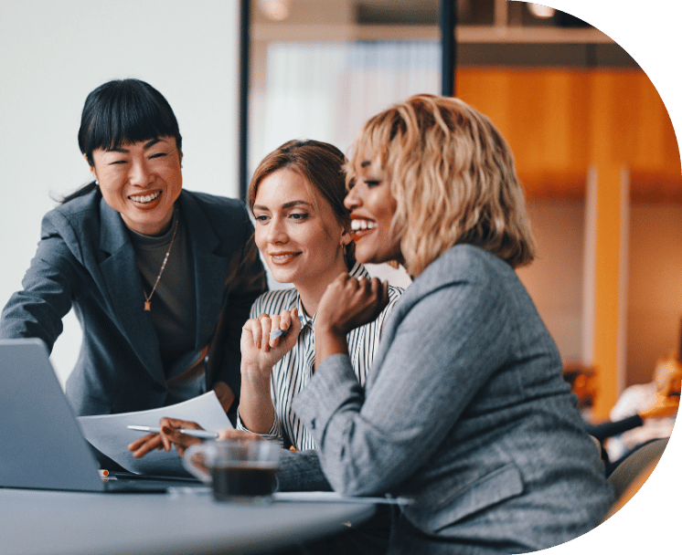 Three coworkers around a laptop