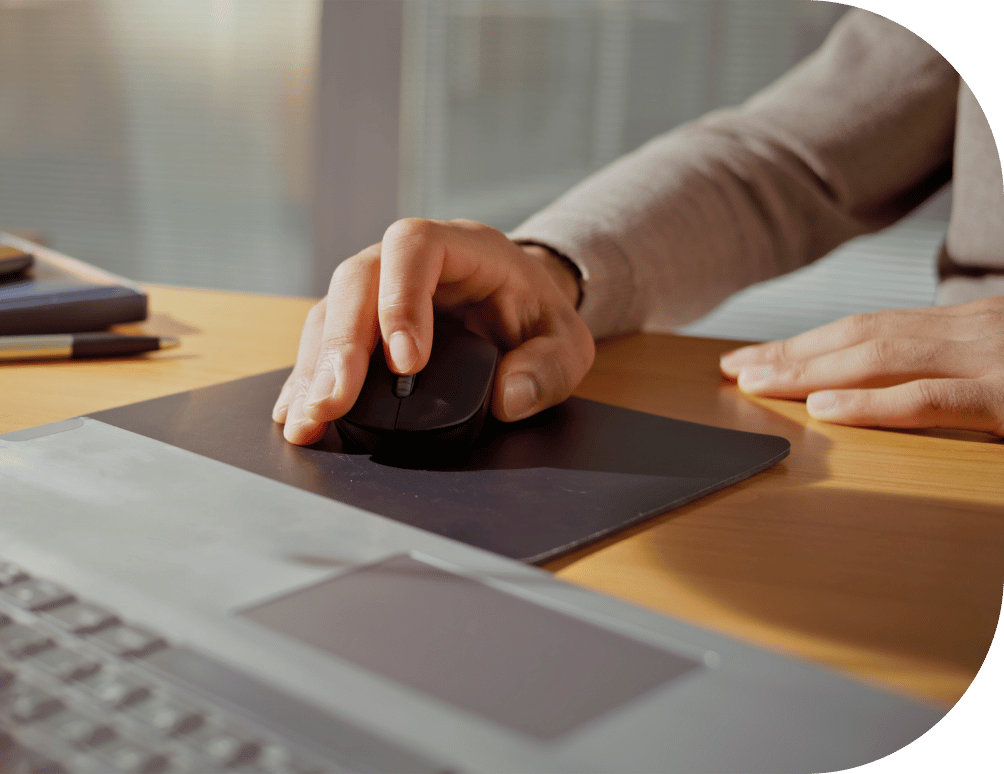 Person moving a mouse on their laptop