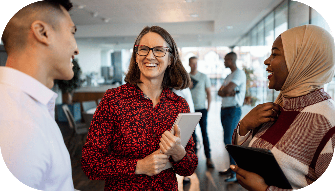 Three coworkers chatting and smiling