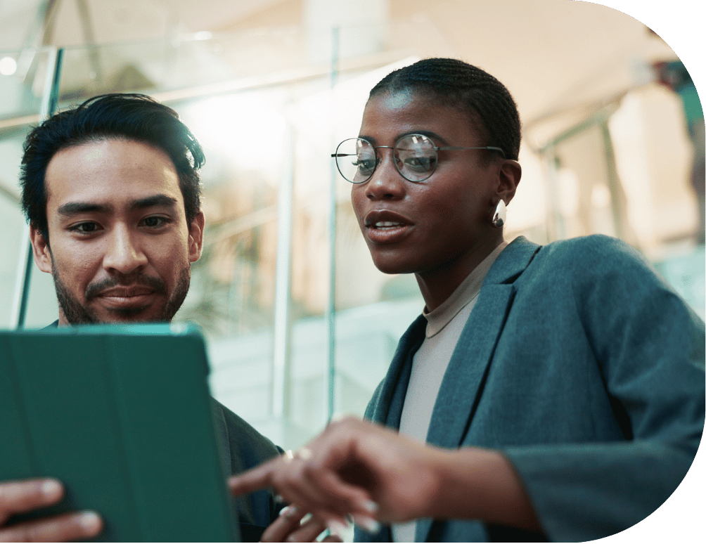 Two coworkers looking at a tablet