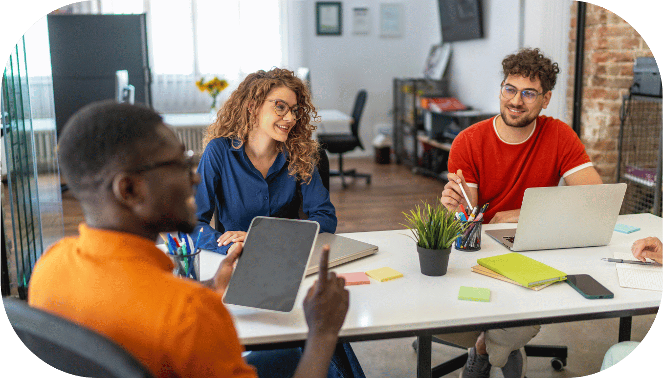 Four coworkers talking over a table