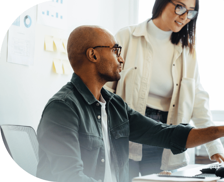 A man and woman collaborating at an office