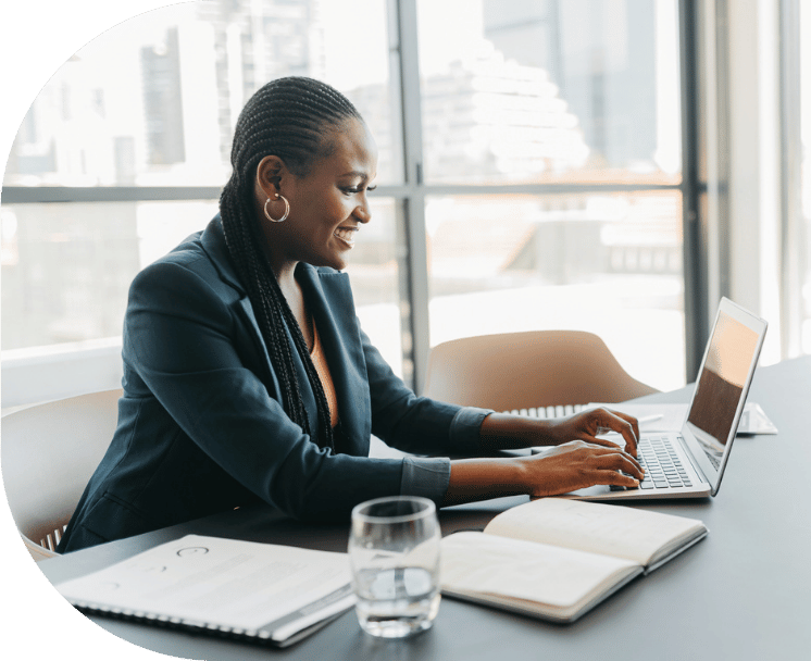 A woman typing on her laptop