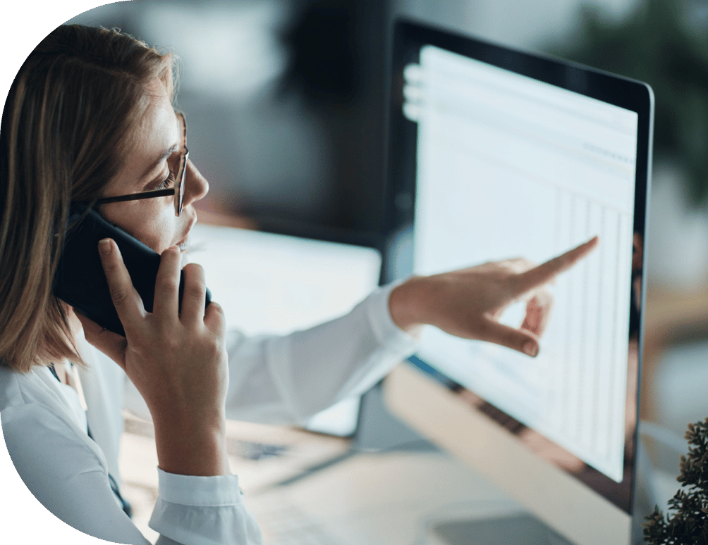 A woman pointing at a desktop screen