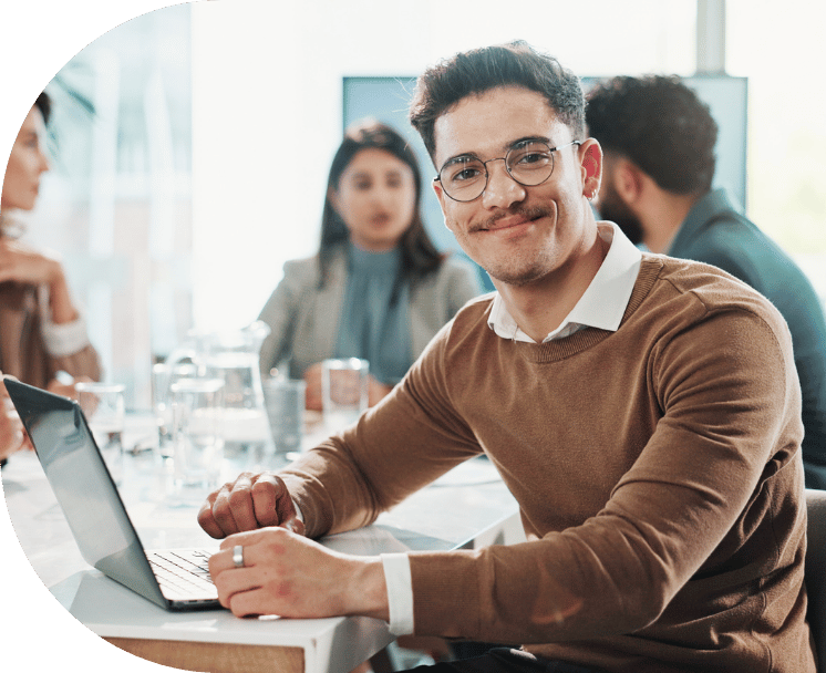 A man smiling in an office meeting