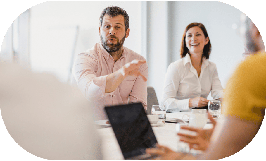 A man speaking to a group in a meeting