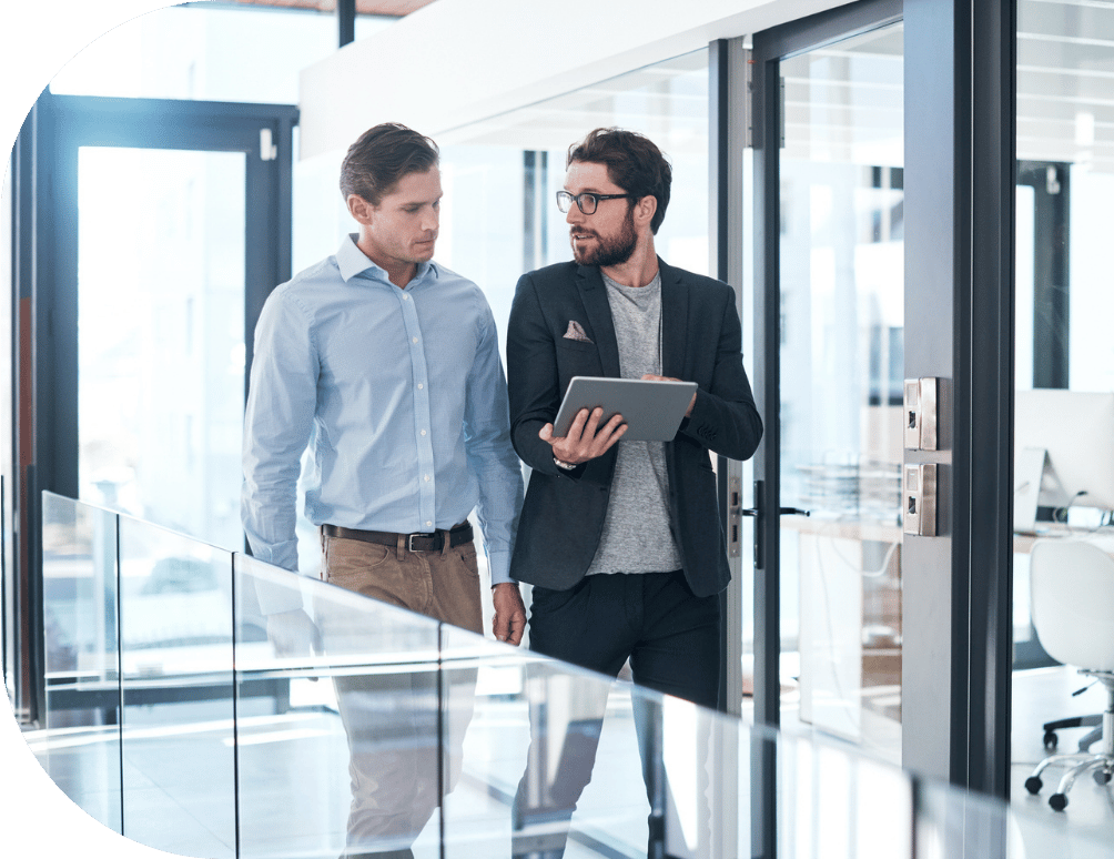 Two men walking in an office