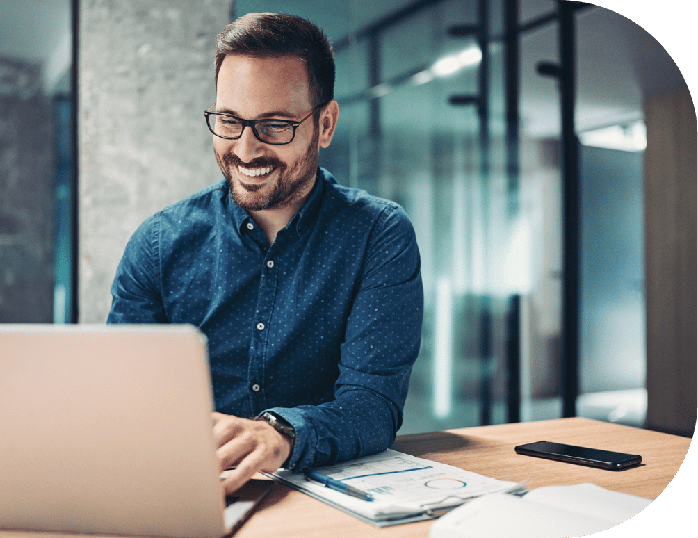 A man smiling and typing