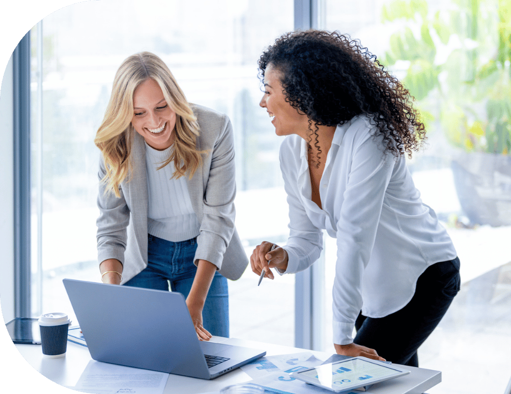 Two women working on a laptop