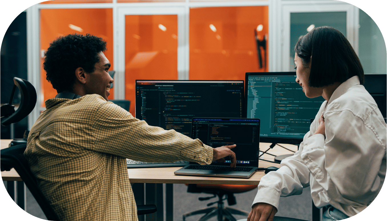 Two coworkers working on code together
