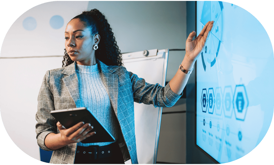A woman gesturing to an analytics presentation