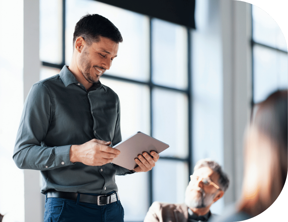 A man holding a tablet in an office