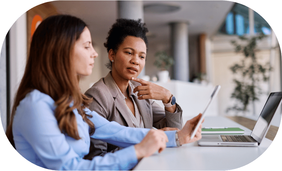 Two women working together on a laptop